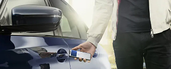 person unlocking car with phone
